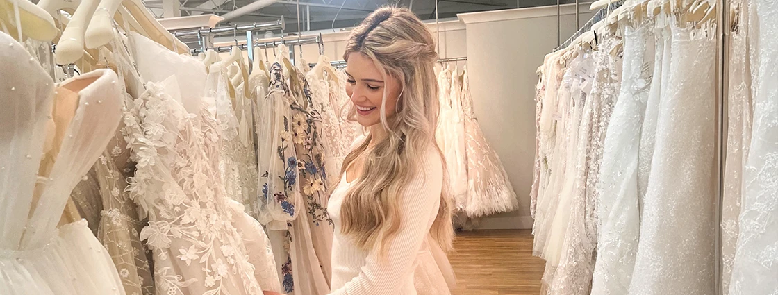 Bride looking through wedding dress gallery