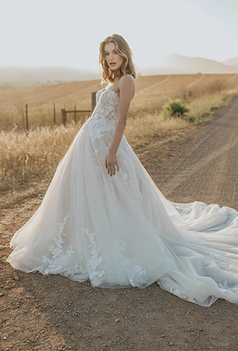 Bride wearing strapless ballgown wedding dress with floral lace 