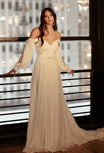 Bride wearing long sleeve boho wedding dress