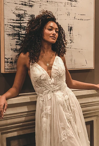 Bride wearing sparkling lace boho wedding dress with v-neckline