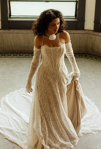 Bride wearing lace wedding dress with sweetheart neckline and optional sleeves