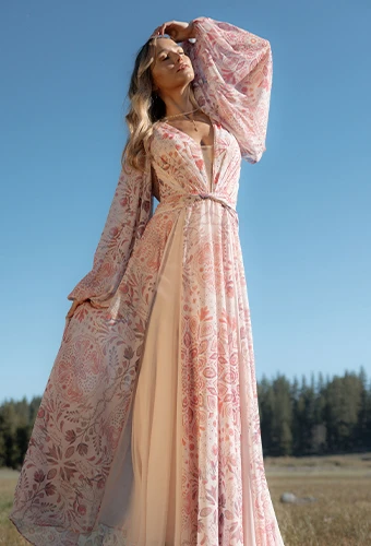 Bride wearing colorful long sleeved wedding dress with floral details