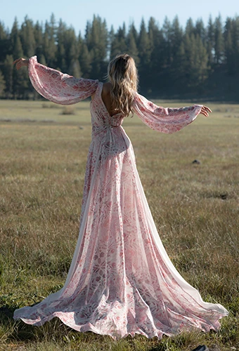 Bride wearing colorful long sleeved wedding dress with floral details