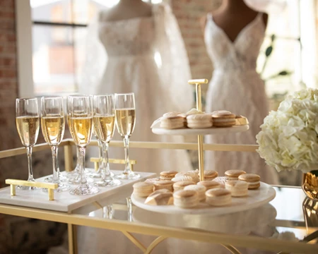 treats and champagne on a table at bridal salon