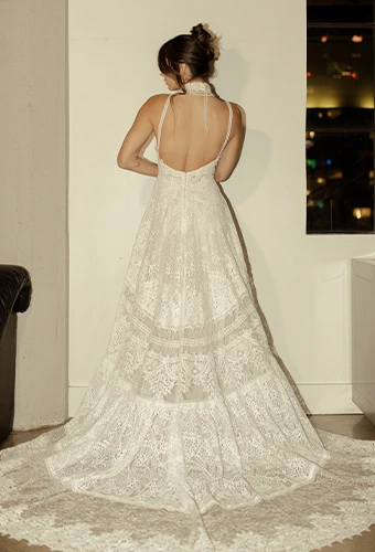 Bride wearing lace wedding dress with low open back