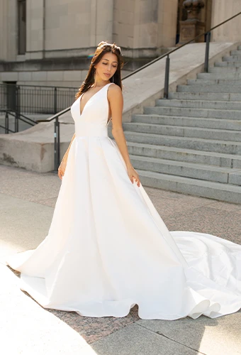 Bride wearing ballgown wedding dress with straps and deep v-neckline