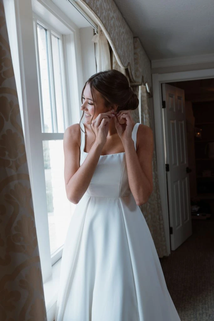 True Bride Genevieve putting on earrings