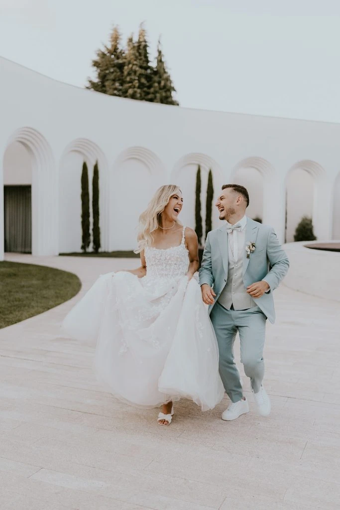 True bride Claudia joyously posing with her husband