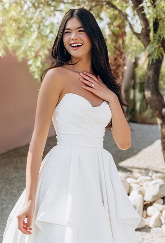 Bride wearing satin strapless ballgown wedding dress with scoop neckline