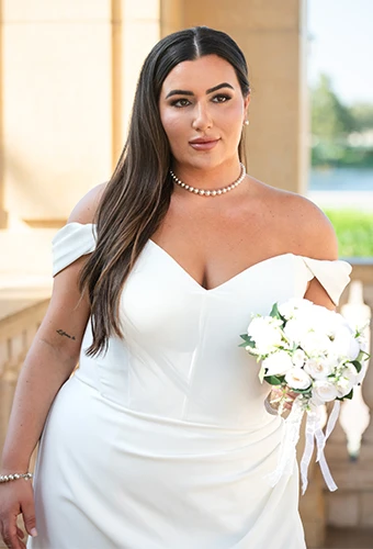 Plus size bride wearing simple wedding dress with sweetheart neckline off-the-shoulder straps