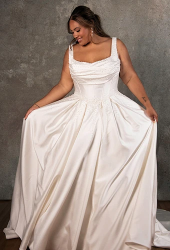 Plus size bride wearing satin mikado ballgown with all over pearls and sweetheart neckline