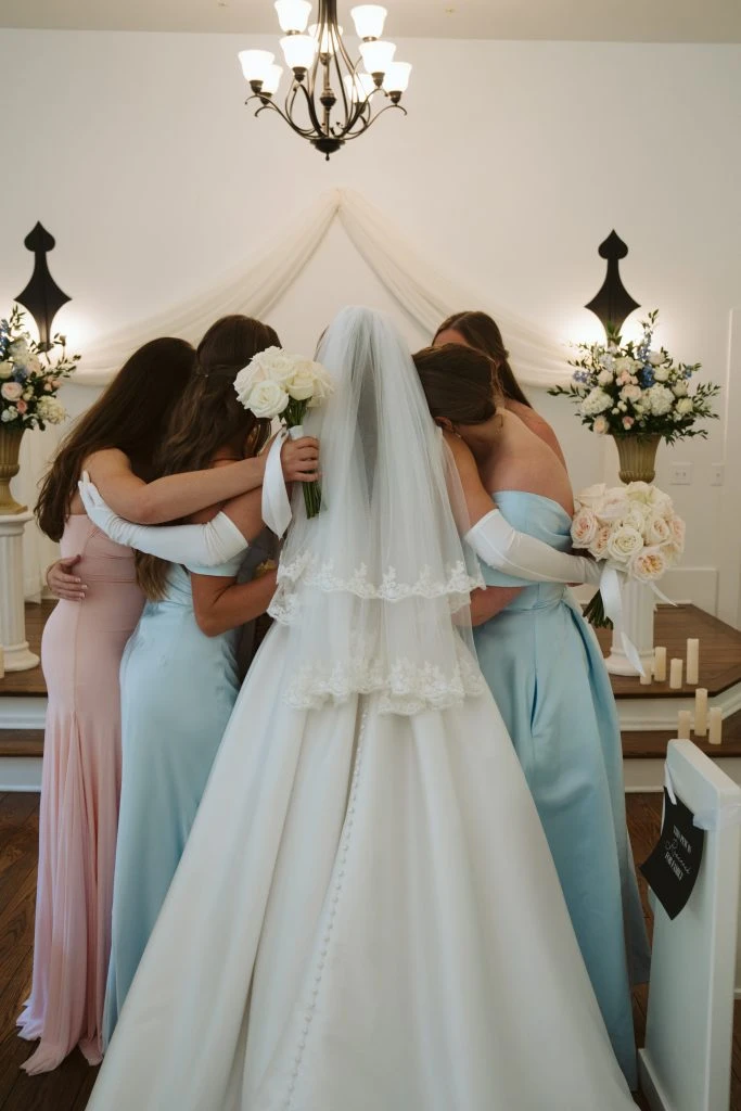 True bride Maya posing with her bridal party at the alter