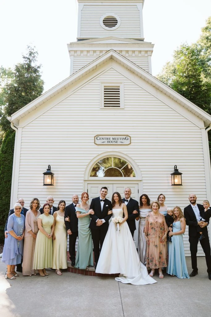 True bride Maya posing with her wedding guest in front of the church