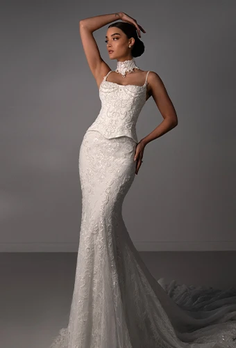 Bride wearing fit-and-flare wedding dresses with beaded details, lace and thin spaghetti straps