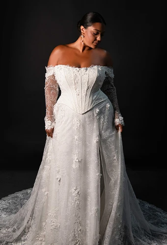 Plus size bride wearing lace wedding dress with sweetheart neckline and long sleeves