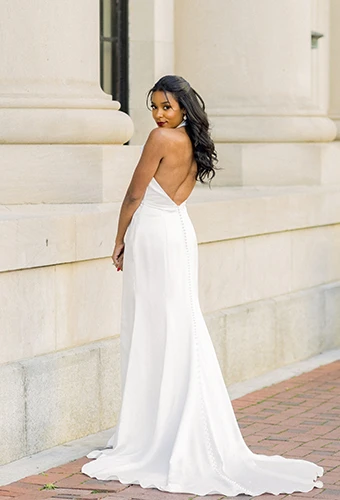Bride wearing simple wedding dress with open back and halter neckline