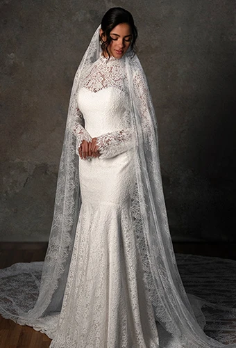 Bride wearing modest long sleeve lace wedding dress with high neckline