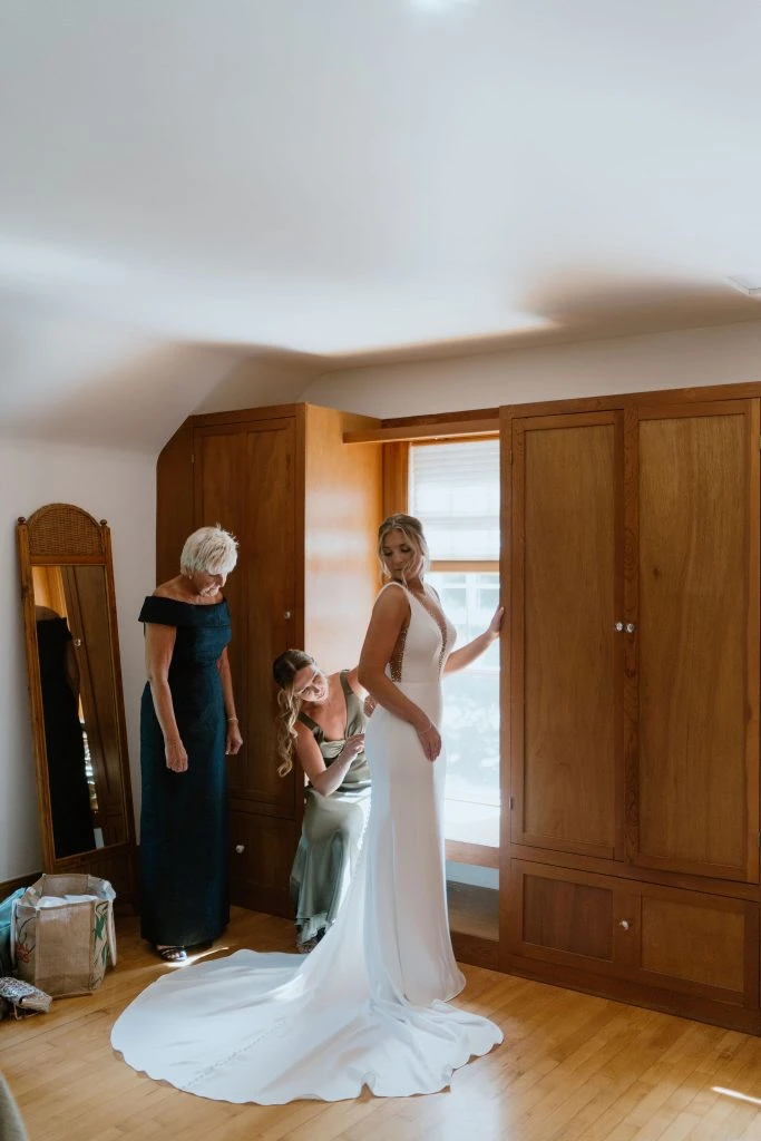 True bride Kelsey putting on her wedding gown