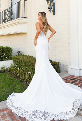 Bride wearing strapless wedding dress with lace train