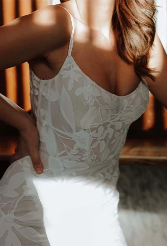 Bride wearing floral lace wedding dress with scoop neckline