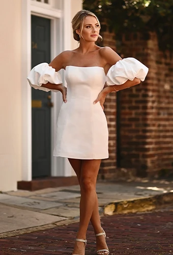 Bride wearing minimalist mini wedding dress with optional puff sleeves
