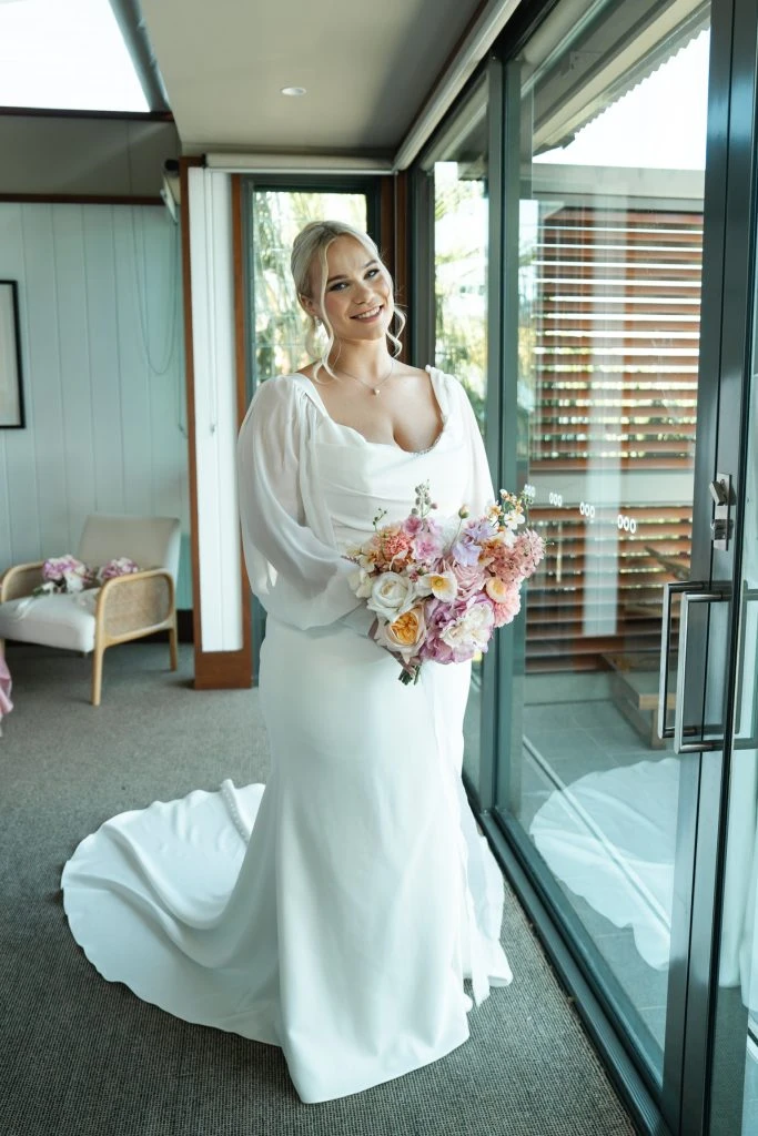 True bride Sophie posing in her wedding gown with bouquet