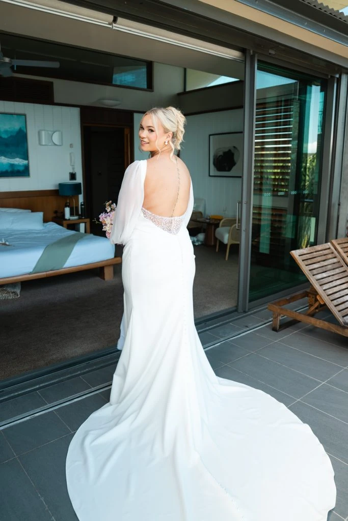 True bride Sophie posing in her wedding gown with bouquet