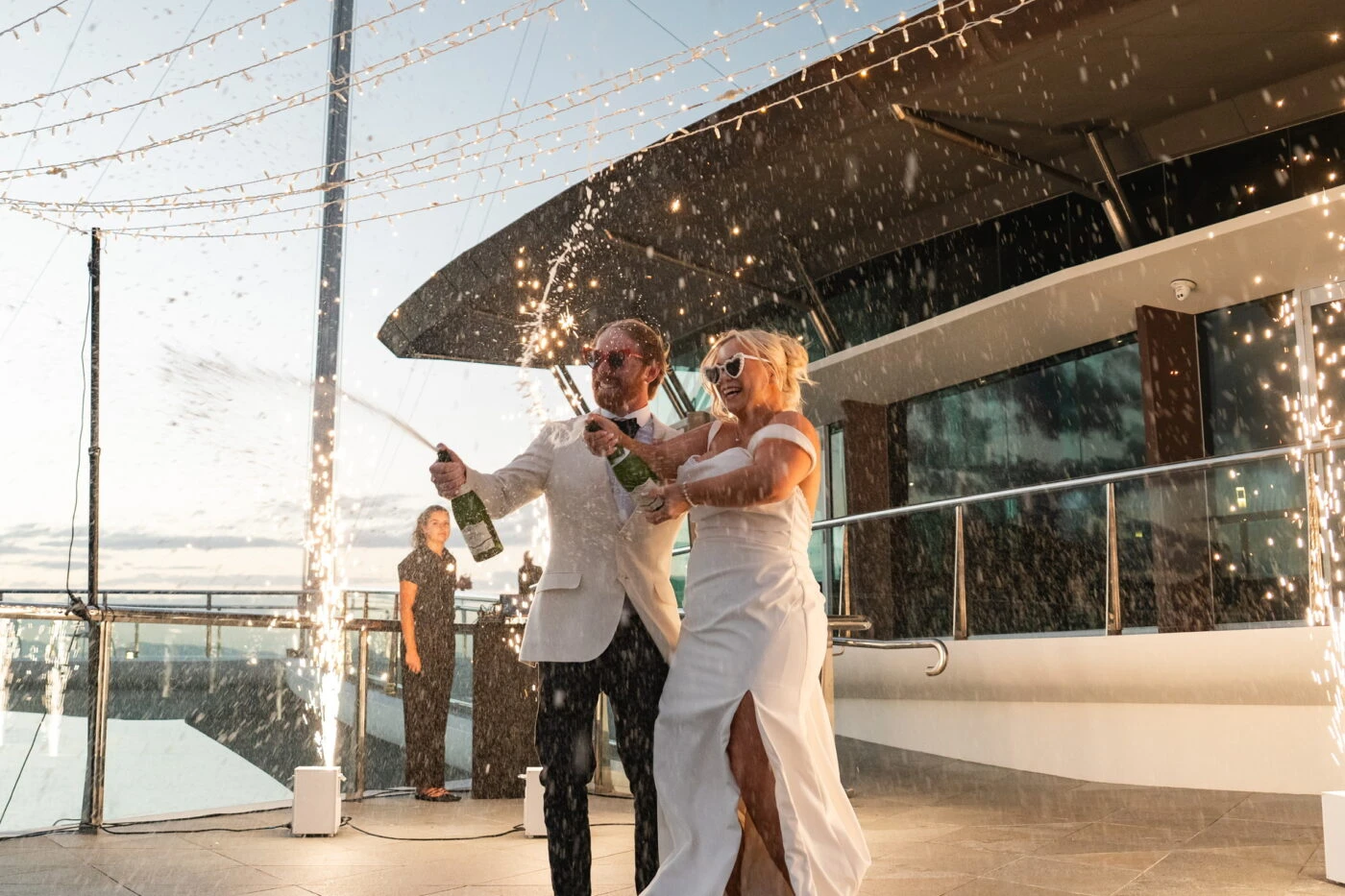 True bride Sophie celebrating with her husband with champagne
