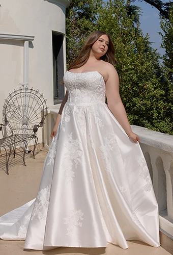 Plus size bride wearing strapless a-line wedding dress with lace details