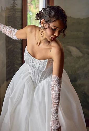 Bride wearing ballgown wedding dress with lace bodice and scoop neckline