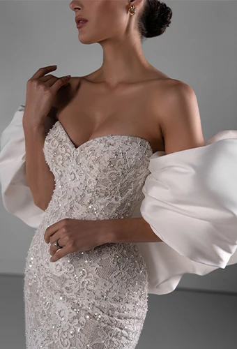 Bride wearing strapless sparkling lace wedding dress with sweetheart neckline and bubble detachable overskirt