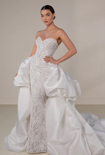 Bride wearing strapless sparkling lace wedding dress with sweetheart neckline and bubble detachable overskirt