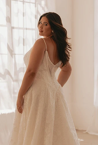 Plus size bride wearing lace wedding dress with v back