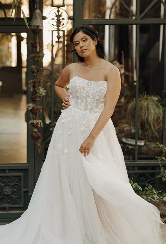 Bride wearing strapless wedding dress with lace appliques