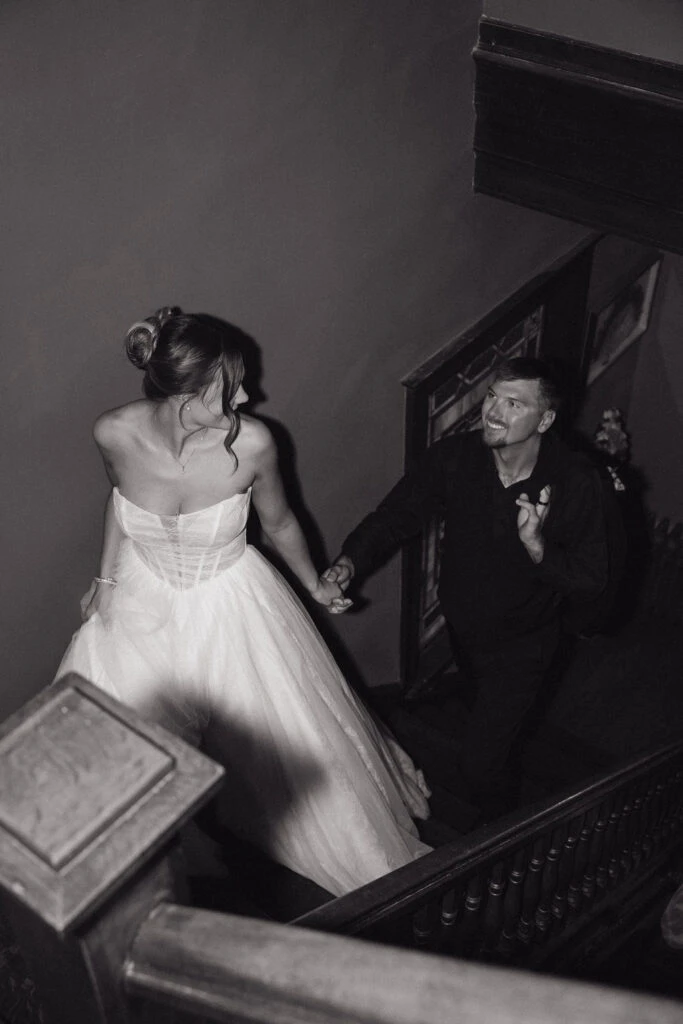 True bride Lauren posing with her husband on a staircase