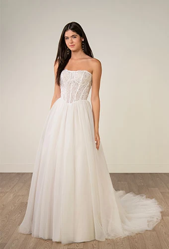 Bride wearing strapless a-line wedding dress with exposed boning and tulle skirt