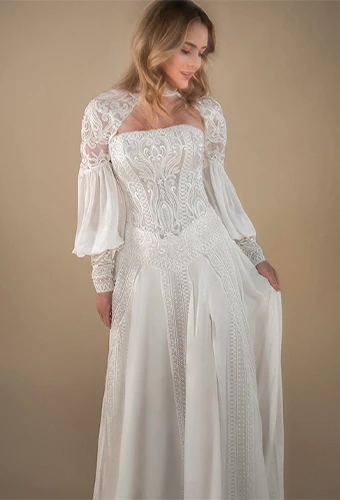 Bride wearing a-line wedding gown with lace bodice and statement sleeves