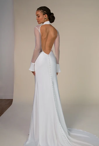 Bride wearing simple wedding dress with long sleeves and open back
