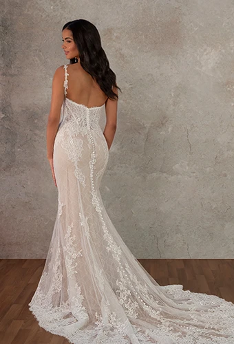 Bride wearing lace fit-and-flare wedding dress with spaghetti straps