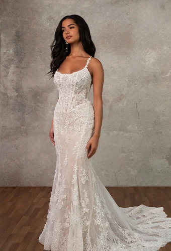 Bride wearing lace fit-and-flare wedding dress with scoop neckline and spaghetti straps