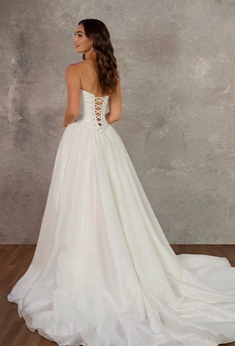 Bride wearing strapless wedding gown with basque waist
