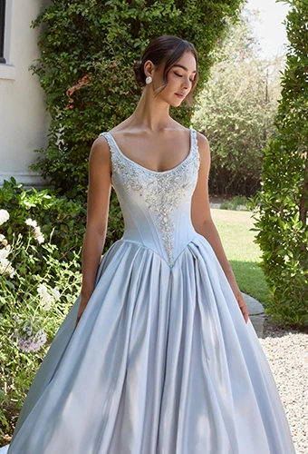 Bride wearing princess ballgown wedding dress with scoop neckline and basque waist
