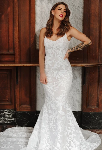 Bride wearing boho lace column wedding dress with thin spaghetti straps