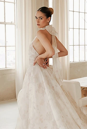 Bride wearing colorful wedding dress with halter neckline and open back