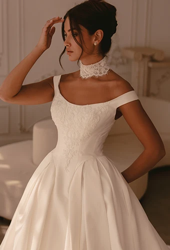 Bride wearing ballgown wedding dress with off-the-shoulder straps