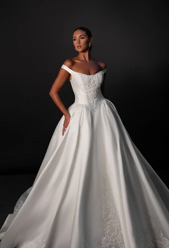 Bride wearing ballgown wedding dress with off-the-shoulder straps
