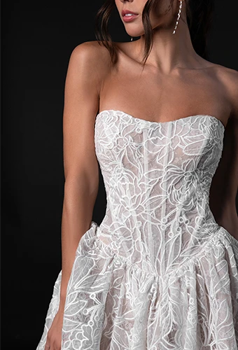 Bride wearing lace wedding dress with sweetheart neckline and basque waist