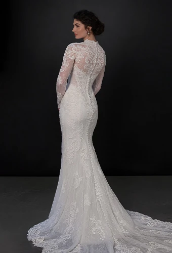 Bride wearing lace wedding dress with long sleeves and overskirt