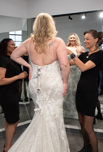 Bridal stylist helping a bride customize neckline