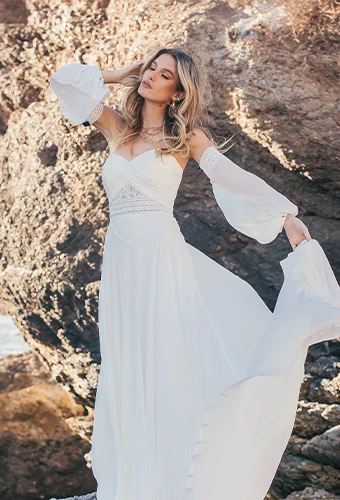 Bride wearing boho a-line wedding dress with sweetheart neckline and detachable sleeves